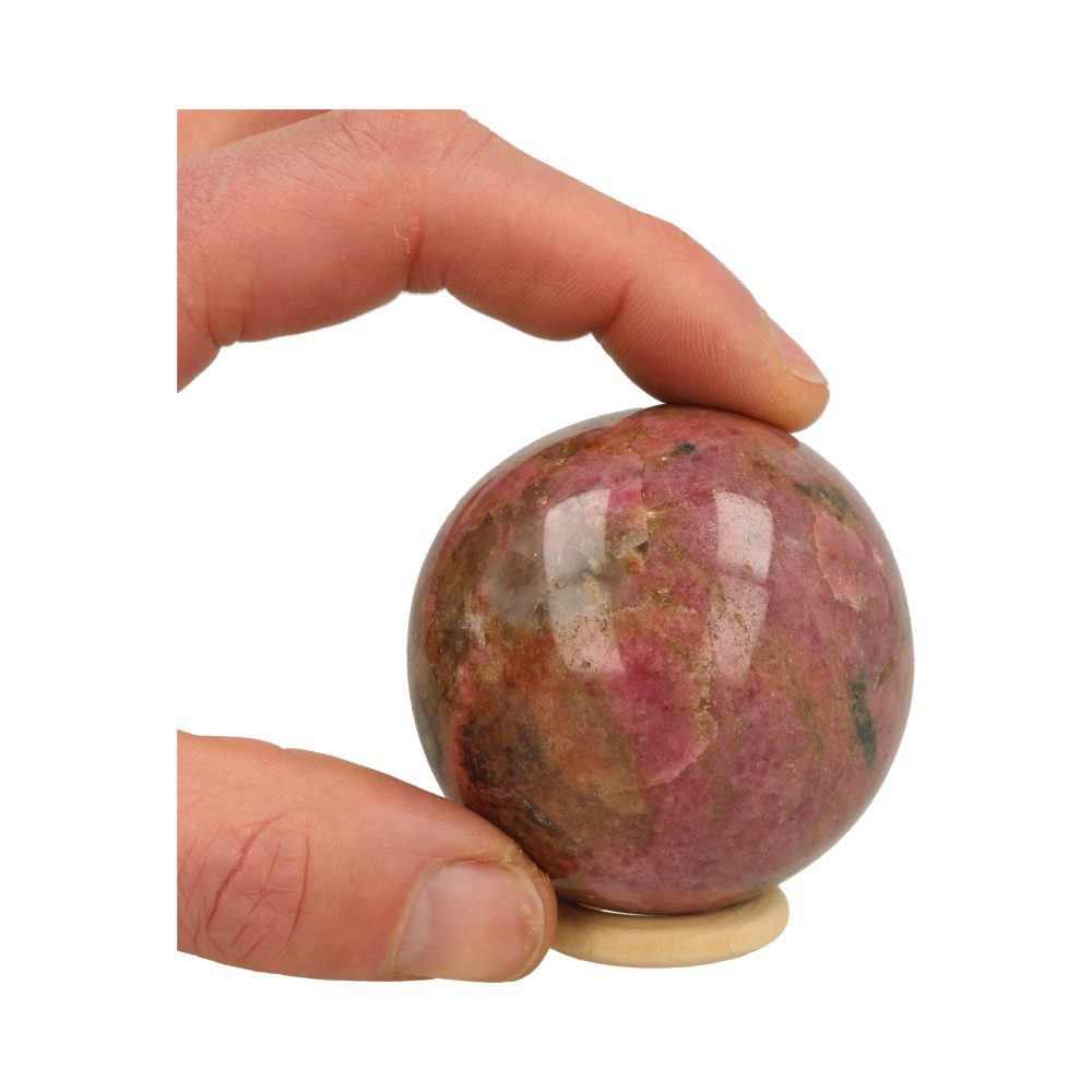 Fraaie rhodoniet bol met diameter van 61mm en geen zwart op houten ring, overzicht in hand