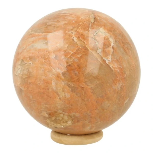 Mooie roze of perzik maansteen bol met een diameter van 69mm op houten ring